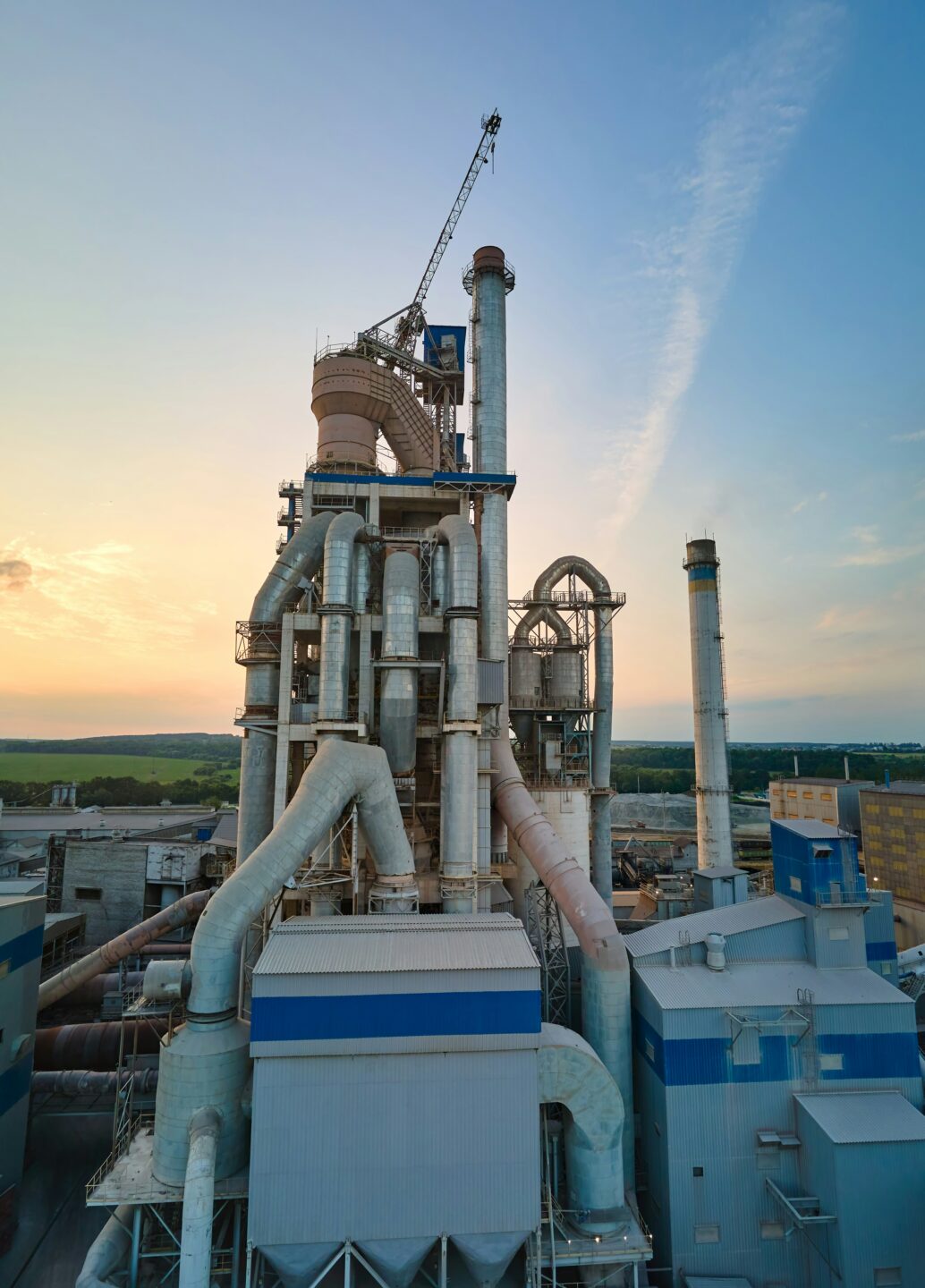 Petrochemical refinery towers and piping at sunset